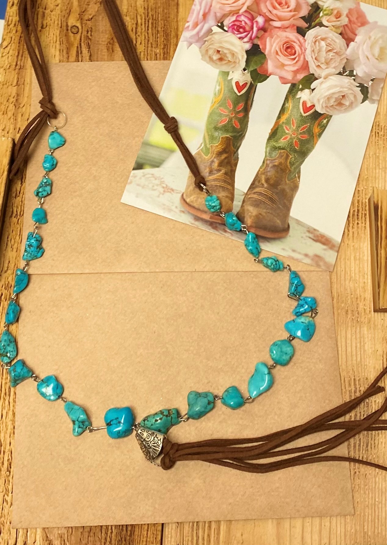 A longer Attitude Necklace of Leather and Turquoise  stones with  Leather strands 